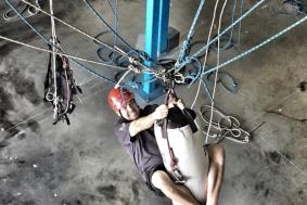 Rope access training student grabbing on a bag while training