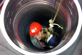 Student practicing rope access training in a confined space