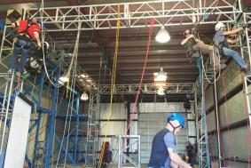 Students at rope access training facility practicing rope training