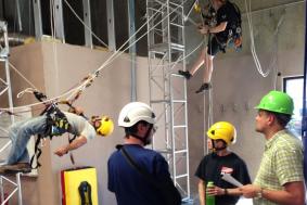 Trainee practicing rope access training by climbing with trainer