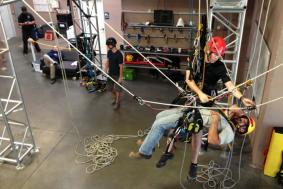 Trainer working with student on proper rope access training procedures