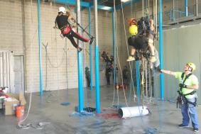 Technician on the floor instructing students on rope proper rope training procedures