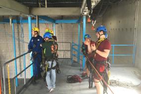 Rope access trainees listening to instructor